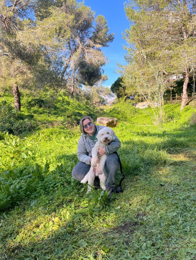 Halyna with a dog on a green trail near Cascais